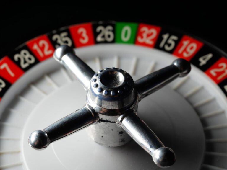 closeup-shot-casino-roulette-wheel-black-surface