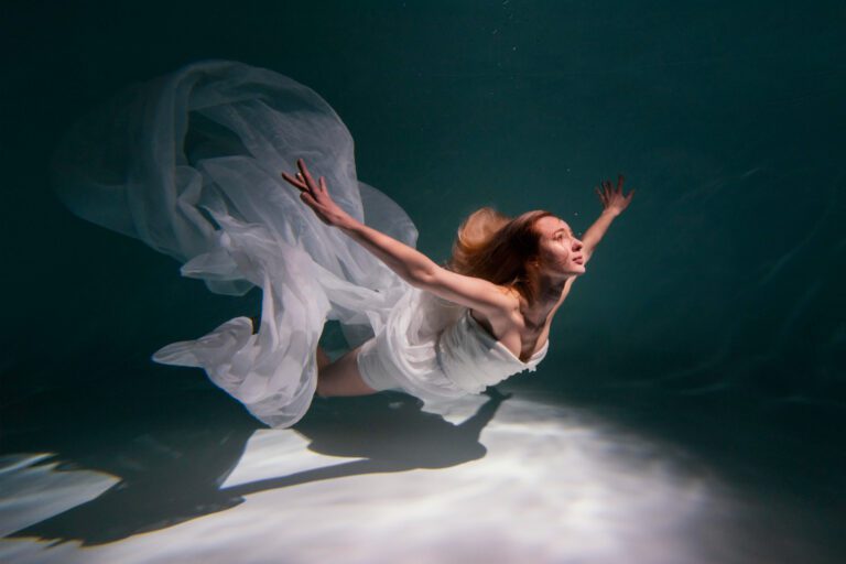 young-woman-posing-submerged-underwater-flowy-dress