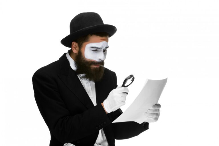 man-with-face-mime-reading-through-magnifying-glass